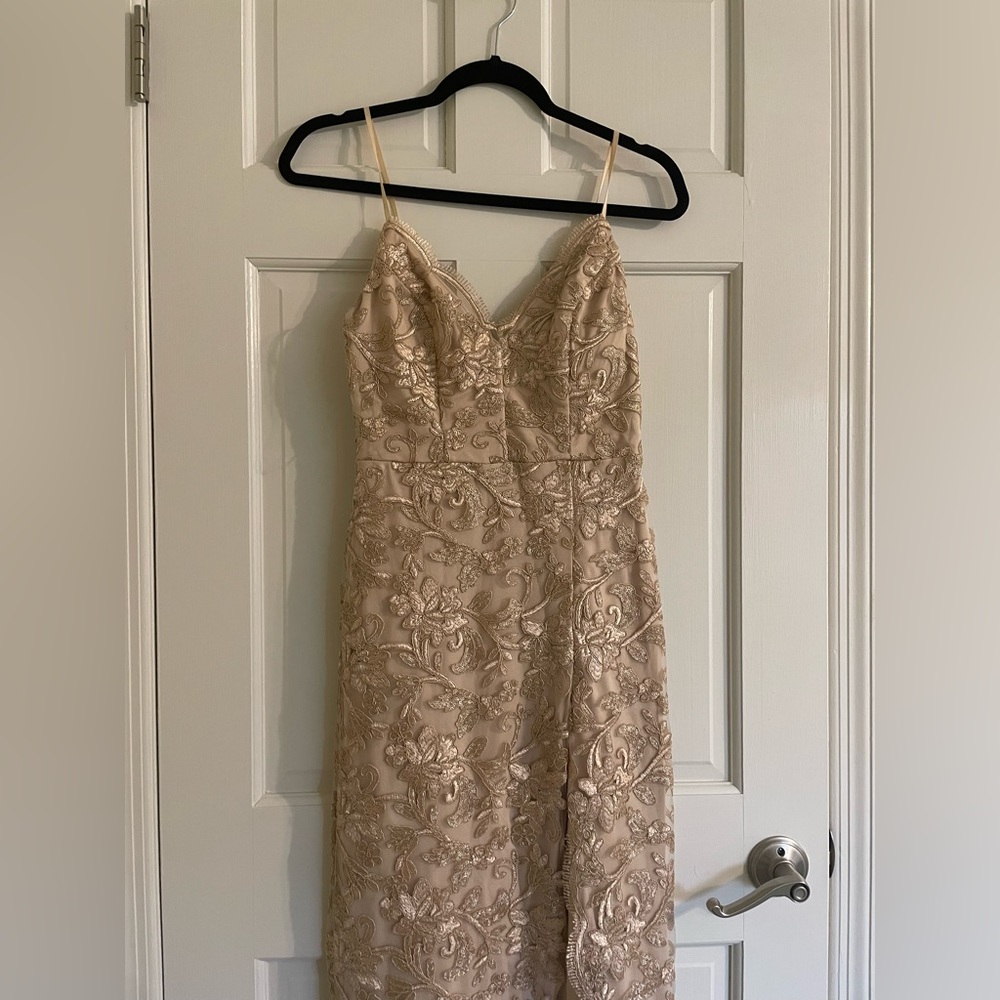 Beautiful golden formal dress with embroidered design and elegant slit.